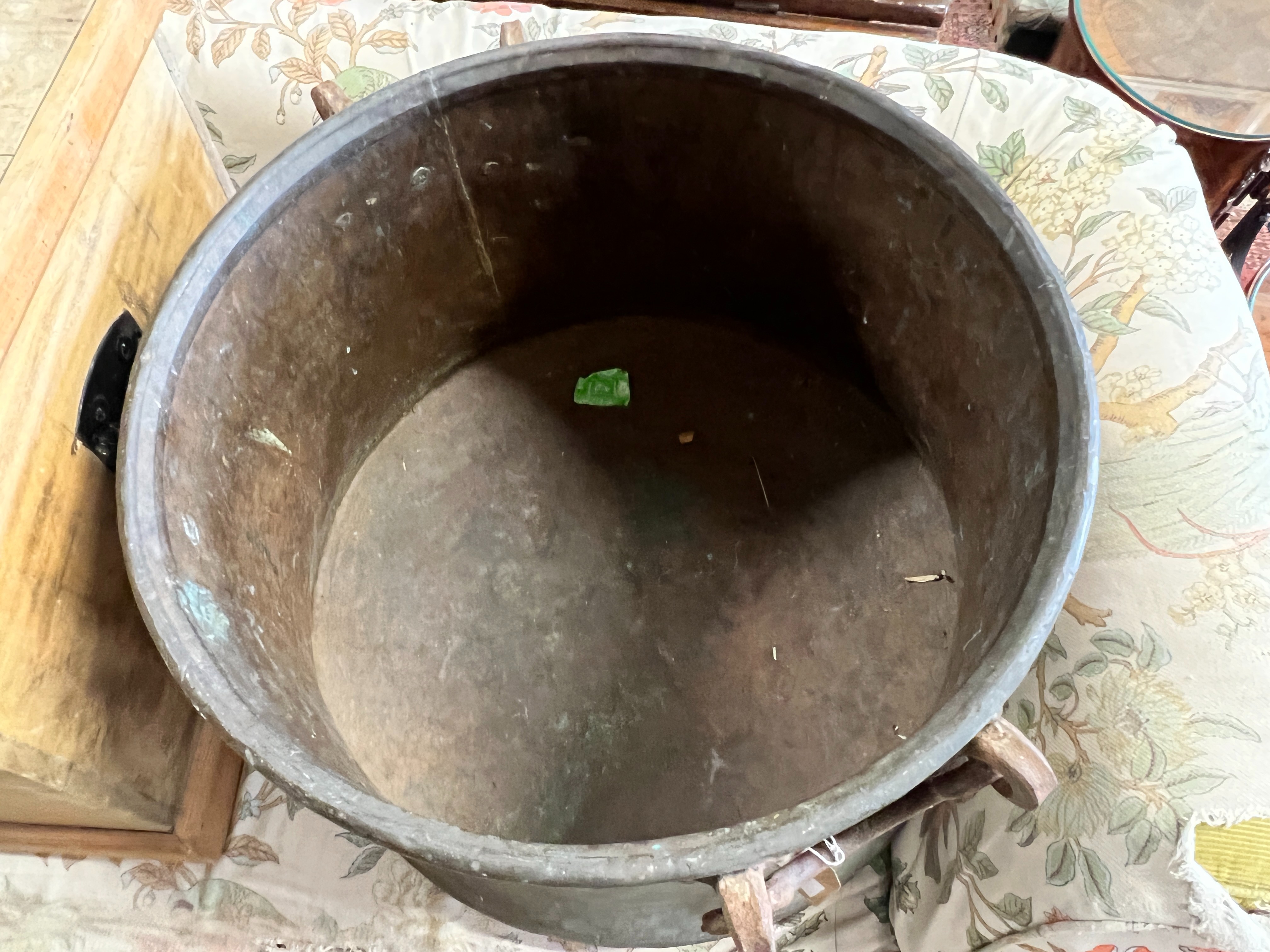 A Victorian circular copper cauldron with wrought iron handles, diameter 56cm, height 42cm
